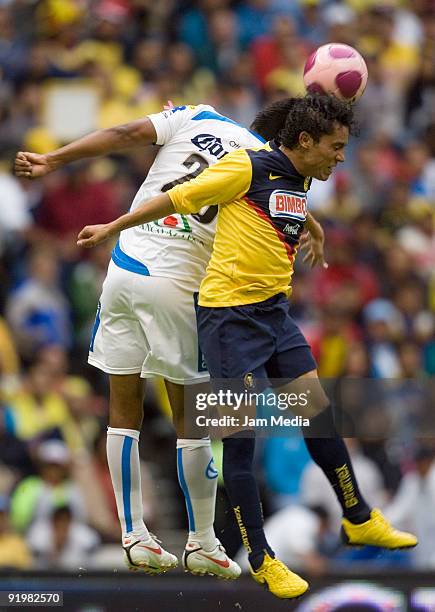 Oscar Velazquez of Puebla vies for the ball with Israel Martinez of America during their match in the 2009 Opening tournament, the closing stage of...