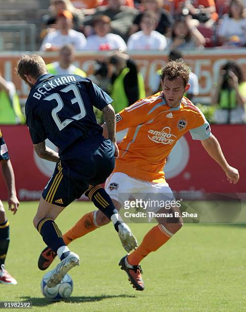 Brad Davis of the Houston Dynamo defends the ball from David Beckham of the Los Angeles Galaxy at Robertson Stadium on October 18, 2009 in Houston,...