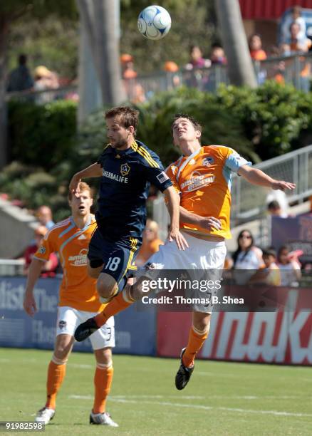 Geoff Cameron of the Houston Dynamo heads the ball from Mike Magee of the Los Angeles Galaxy at Robertson Stadium on October 18, 2009 in Houston,...