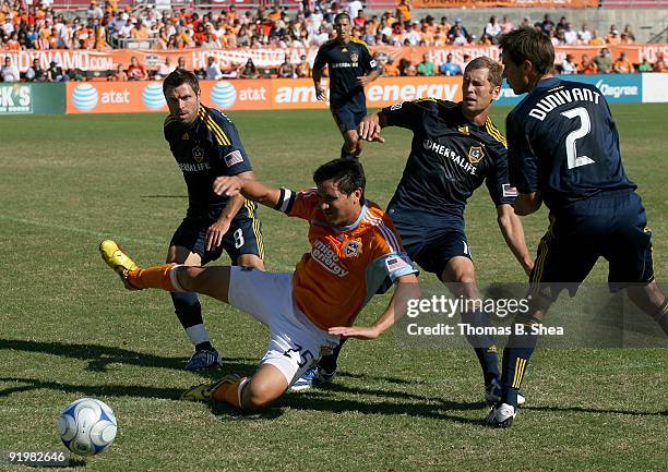 Brian Ching of the Houston Dynamo is tackled by Gregg Berhalter and a sea of Los Angeles Galaxy players at Robertson Stadium on October 18, 2009 in...