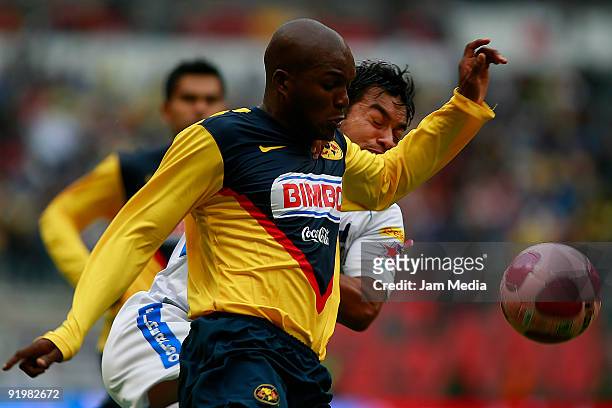 Aquivaldo Mosquera of America vies for the ball with Carlos Ruiz of Puebla during their match in the 2009 Opening tournament, the closing stage of...