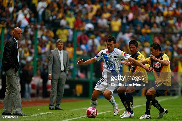 Puebla's head coach Jose Luis Sanchez and America's head coach Jesus Ramirez watch their players Jared Borgetti of Puebla, Juan Carlos Valenzuela and...