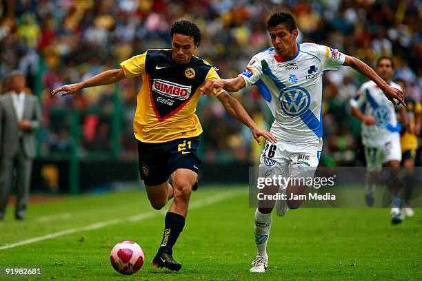 Enrique Esqueda of America vies for the ball with Roberto Juarez of Puebla during their match in the 2009 Opening tournament, the closing stage of...