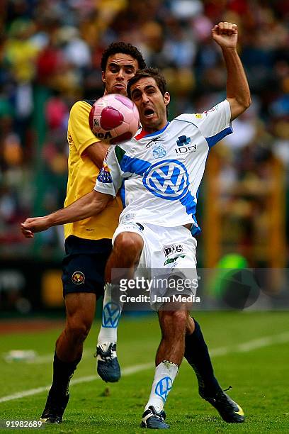 Enrique Esqueda of America vies for the ball with Pablo Aja of Puebla during their match in the 2009 Opening tournament, the closing stage of the...