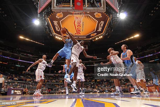 Eric Maynor of the Utah Jazz has his shot challenged by DeSagana Diop of the Charlotte Bobcats at Staples Center on October 18, 2009 in Los Angeles,...
