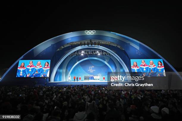 Silver medalists Anna Haag, Charlotte Kalla, Ebba Andersson and Stina Nilsson of Sweden, gold medalists Ingvild Flugstad Oestberg, Astrid Uhrenholdt...