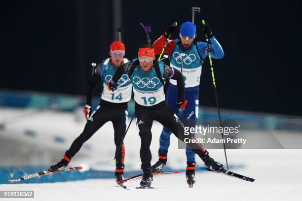 Erik Lesser of Germany competes with Martin Fourcade of France and Simon Schempp of Germany during the Men's 15km Mass Start Biathlon on day nine of...
