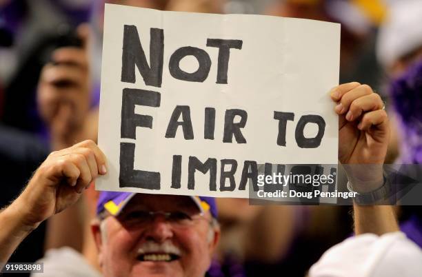 Fan holds a sign in support of Rush Limbaugh as the Minnesota Vikings host the Baltimore Ravens during NFL action at Hubert H. Humphrey Metrodome on...