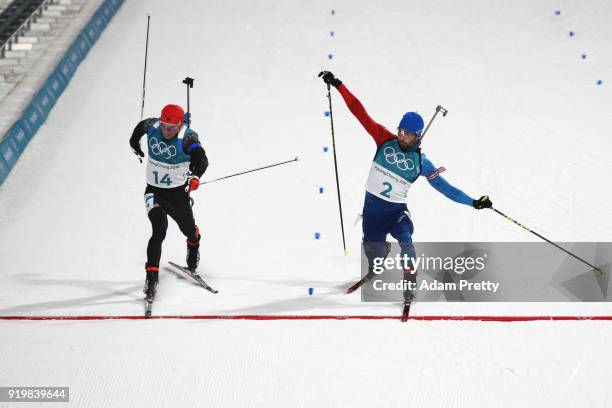 Martin Fourcade of France narrowly wins the gold medal from silver medallist Simon Schempp of Germany during the Men's 15km Mass Start Biathlon on...