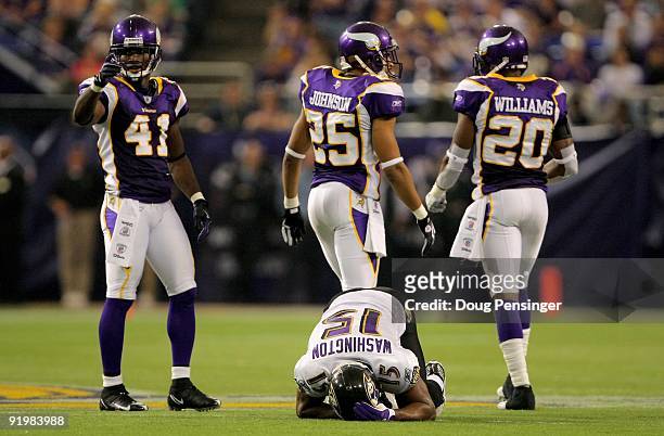 Wide receiver Kelley Washington of the Baltimore Ravens is shaken up after making a reception as Karl Paymah, Tyrell Johnson and Madieu Williams of...