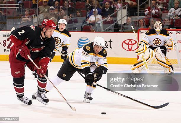 Guillaume Lefebvre of the Boston Bruins defends against Jim Vandermeer of the Phoenix Coyotes during the NHL game at Jobing.com Arena on October 17,...