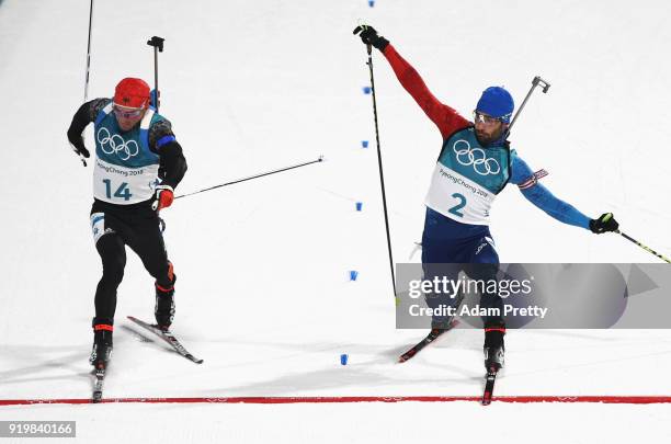 Martin Fourcade of France narrowly wins the gold medal from silver medallist Simon Schempp of Germany during the Men's 15km Mass Start Biathlon on...