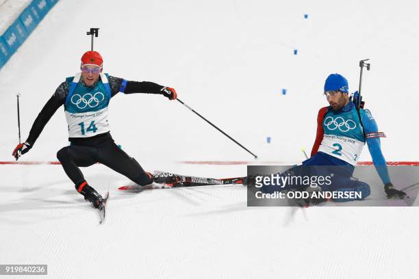 Germany's Simon Schempp and France's Martin Fourcade collapse after crossing the finish line in the men's 15km mass start biathlon event during the...