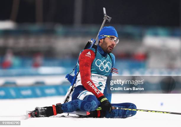 Martin Fourcade of France sits in the snow after winning the gold medal during the Men's 15km Mass Start Biathlon on day nine of the PyeongChang 2018...