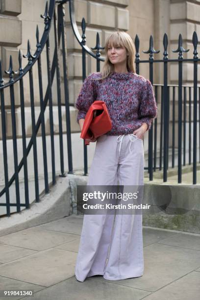 Fashion editor at Costume Magazine Jeanette Friis Madsen wears a Ganni jumper and trousers, Designers Remix bag on day one of London Womens Fashion...