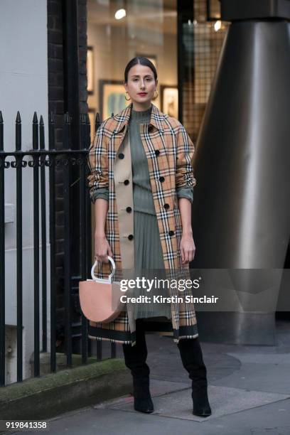 Creative director Julia Haghjoo wears a Burberry coat, Danse Lente bag, Maria Black earrings, Gianvito Rossi boots and an Uzwei dress on day one of...