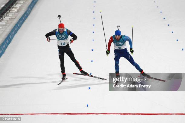 Martin Fourcade of France narrowly wins the gold medal from silver medallist Simon Schempp of Germany during the Men's 15km Mass Start Biathlon on...