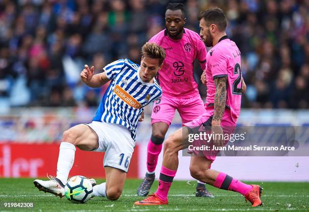 Sergio Canales of Real Sociedad being followed by Cheik Doukoure of Levante UD and Antonio Luna of Levante UD during the La Liga match between Real...