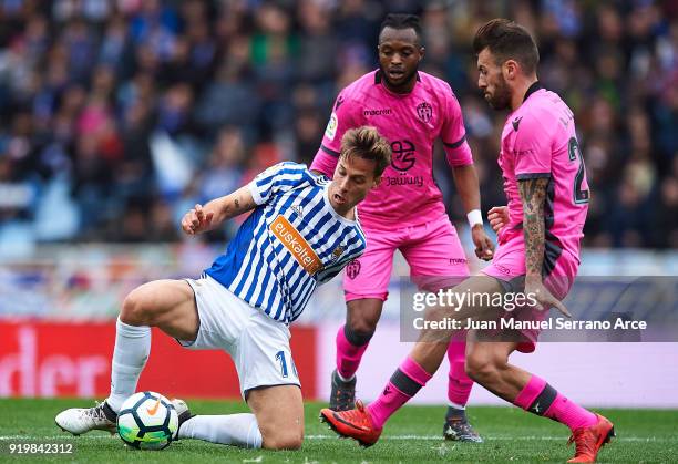 Sergio Canales of Real Sociedad being followed by Cheik Doukoure of Levante UD and Antonio Luna of Levante UD during the La Liga match between Real...