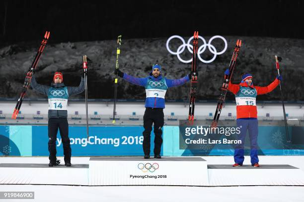 Gold medallist Martin Fourcade of France poses with silver medallist Simon Schempp of Germany and bronze medallist Emil Hegle Svendsen of Norway...
