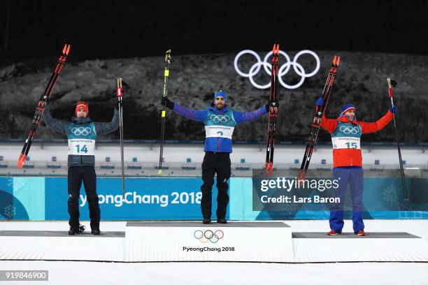 Gold medallist Martin Fourcade of France poses with silver medallist Simon Schempp of Germany and bronze medallist Emil Hegle Svendsen of Norway...