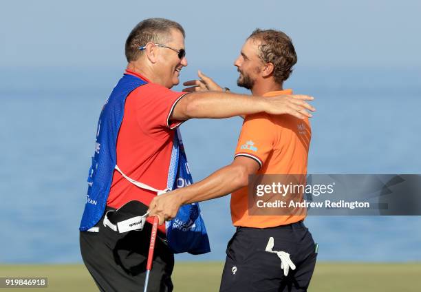 Joost Luiten of the Netherlands and his caddie Michael Waite celebrate victory on the 18th green during the final round of the NBO Oman Open at Al...