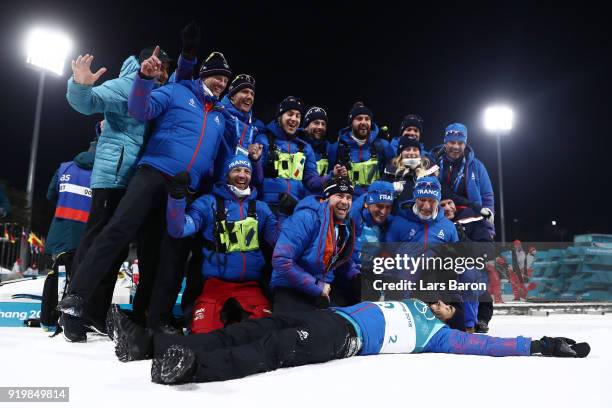Gold medallist Martin Fourcade of France celebrates with his team during the victory ceremony for the Men's 15km Mass Start Biathlon on day nine of...