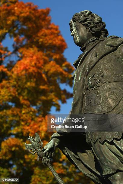 Statue of Frederick I, King of Prussia, stands next to an autumn tree in the gardens of Schloss Charlottenburg palace on October 19, 2009 in Berlin,...