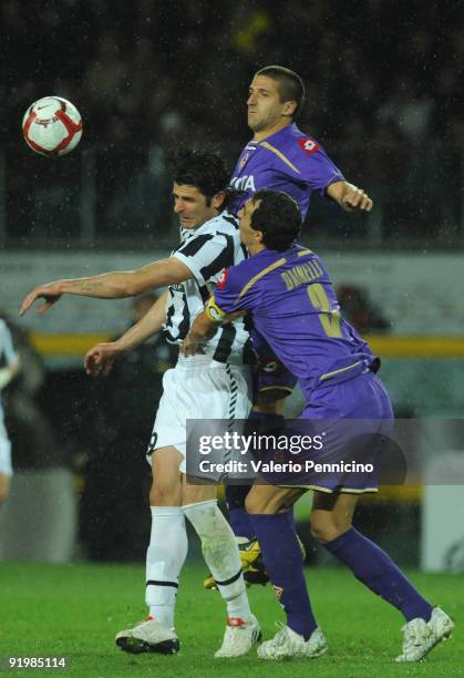 Vincenzo Iaquinta of Juventus FC is challenged by Dario Dainelli and Alessandro Gamberini of ACF Fiorentina during the Serie A match between Juventus...