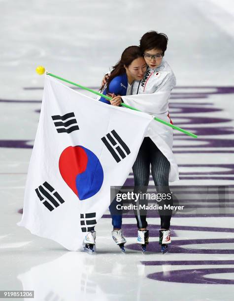 Nao Kodaira of Japan and Sang-Hwa Lee of Korea celebrate after winning the gold and silver medal, respectively, during the Ladies' 500m Individual...