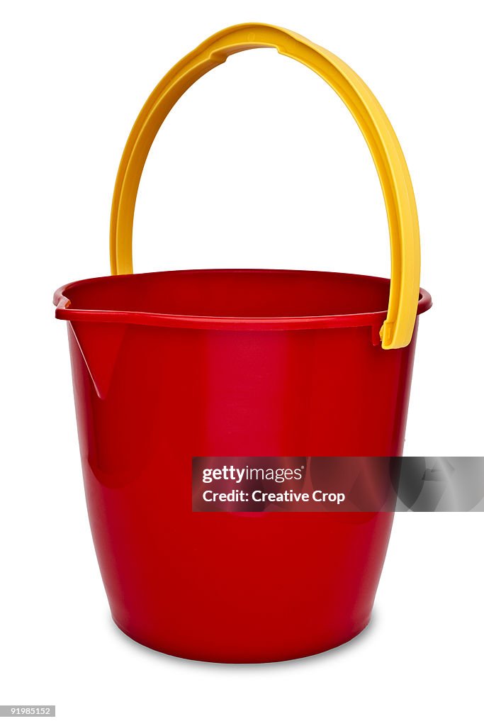 Red plastic bucket with yellow handle