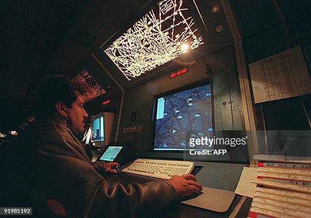 Flight controller Jose Luis Amezcua checks his radar targets at Mexico City's international airport 29 December two days before the possible Y2K...