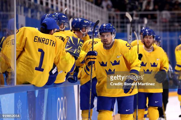 Anton Lander of Sweden celebrates with teammates after scoring in the first period against Finland during the Men's Ice Hockey Preliminary Round...