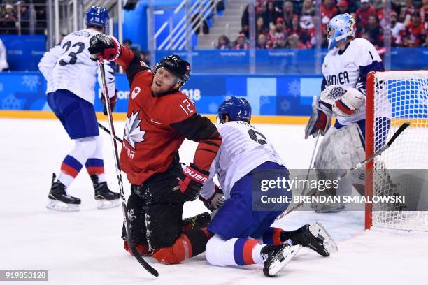 Canada's Rob Klinkhammer reacts after clashing with South Korea's Bryan William Young in the men's preliminary round ice hockey match between Canada...