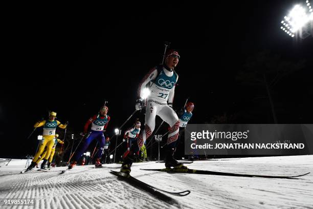 Sweden's Sebastian Samuelsson South Korea's Lapshin Timofei and Latvia's Andrejs Rastorgujevs compete in the men's 15km mass start biathlon event...