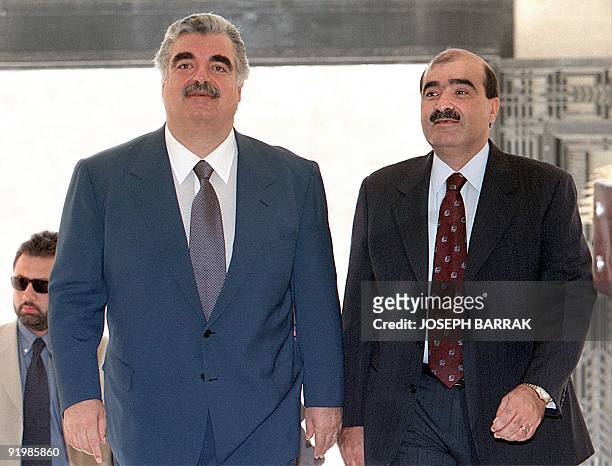 Lebanese Prime Minister Rafic Hariri and Information Minister Bassem al-Sabaa arrive 13 October to the Parliament to attend the Parliament session...