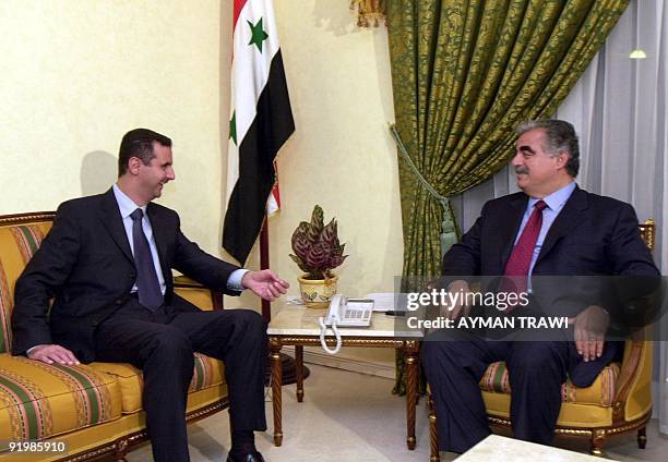 Syrian President Bashar al-Assad meets with Lebanese Prime Minister Rafic Hariri in Doha 11 November 2000. The two leaders are in the Qatari capital...