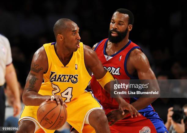 Kobe Bryant of the Los Angeles Lakers drives against Baron Davis of the Los Angeles Clippers during a preseason game at Staples Center on October 18,...