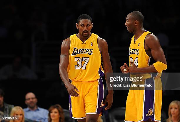Kobe Bryant of the Los Angeles Lakers talks to teammate Ron Artest during a preseason game against the Los Angeles Clippers at Staples Center on...