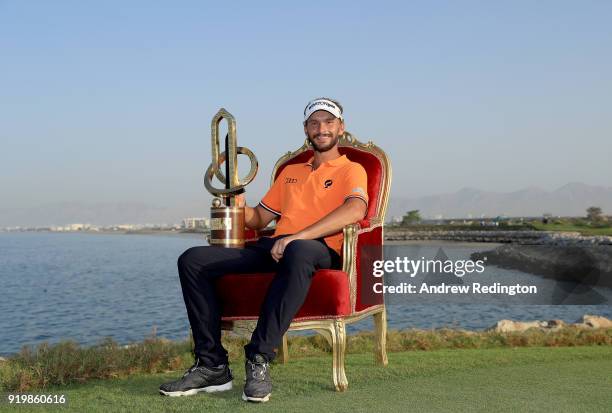 Joost Luiten of the Netherlands celebrates with the winners trophy after the final round of the NBO Oman Open at Al Mouj Golf on February 18, 2018 in...