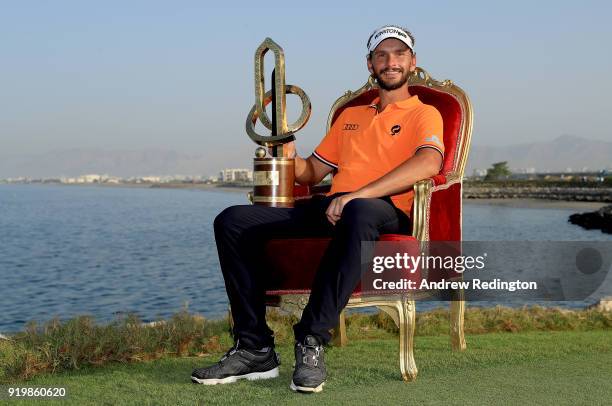 Joost Luiten of the Netherlands celebrates with the winners trophy after the final round of the NBO Oman Open at Al Mouj Golf on February 18, 2018 in...