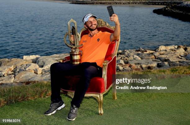 Joost Luiten of the Netherlands celebrates with the winners trophy after the final round of the NBO Oman Open at Al Mouj Golf on February 18, 2018 in...