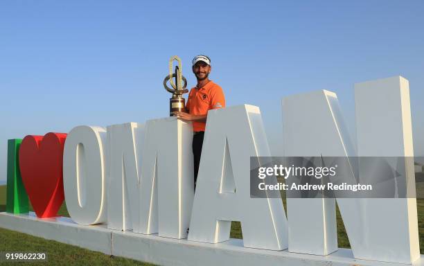 Joost Luiten of the Netherlands celebrates with the winners trophy after the final round of the NBO Oman Open at Al Mouj Golf on February 18, 2018 in...