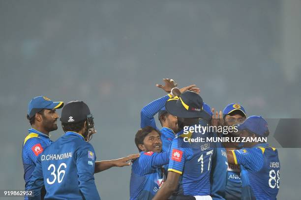 Sri Lanka cricketer Akila Dananjaya celebrates with his teammate after the dismissal of the Bangladesh cricketer Soumya Sarkar during the second...