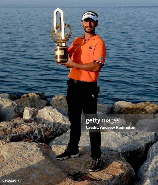 Joost Luiten of the Netherlands celebrates with the winners trophy after the final round of the NBO Oman Open at Al Mouj Golf on February 18, 2018 in...