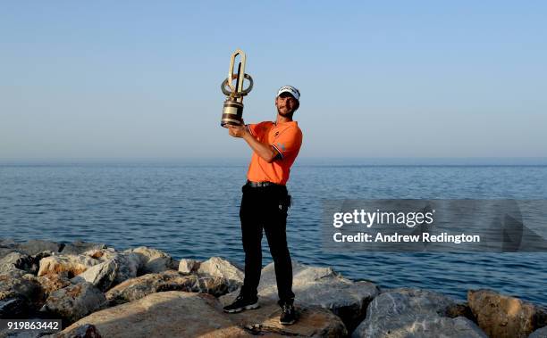 Joost Luiten of the Netherlands celebrates with the winners trophy after the final round of the NBO Oman Open at Al Mouj Golf on February 18, 2018 in...