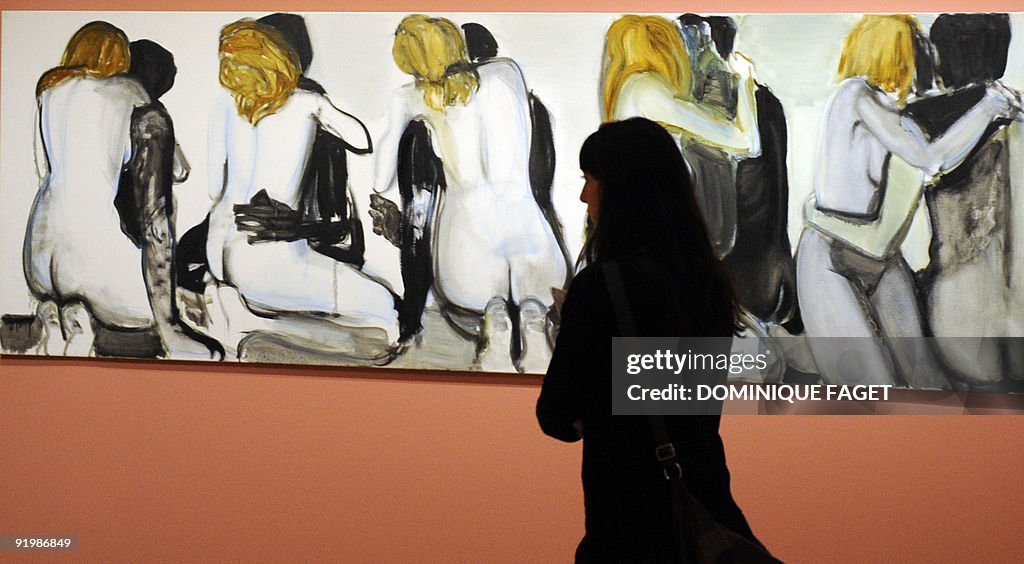 A visitor looks at the painting "Couples