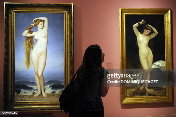 Visitor looks at the painting "The birth of Venus" by Eugene Emmanuel Amaury-Duval and "Bather" of William Adolphe Bouguereau during the opening of...