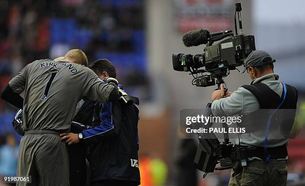 Wigan Athletic's English goalkeeper Chris Kirkland receives attention to his finger during the English Premier League football match between Wigan...