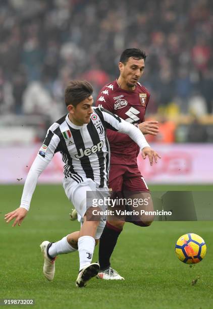 Nicolas Burdisso of Torino FC competes with Paulo Dybala of Juventus during the Serie A match between Torino FC and Juventus at Stadio Olimpico di...